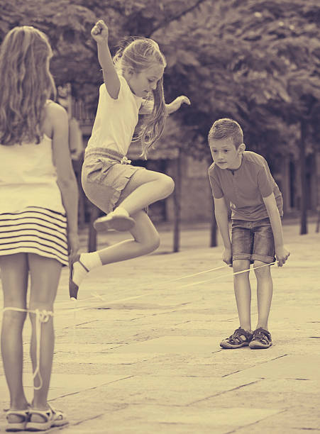istock Kids skipping on  elastic rope 628617522
