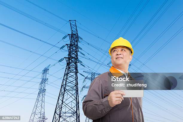 Asian Old Man Engineer With Tablet And Pylons Stock Photo - Download Image Now - Agricultural Field, Digital Tablet, Electricity