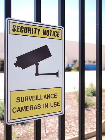 Camera surveillance sign on a steel fence of an industrial estate, Melbourne, Australia 2016