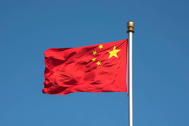 istock Flying Chinese National Falg against blue sky 628647748