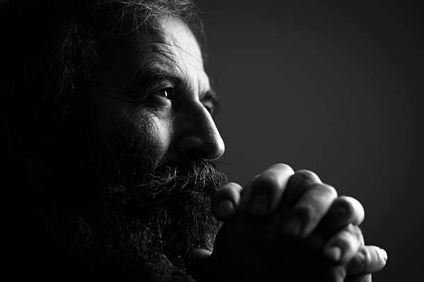 close-up of man praying - black and white bildbanksfoton och bilder