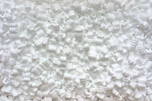 White S-shaped, anti-static, polystyrene packing peanuts shown from above. 