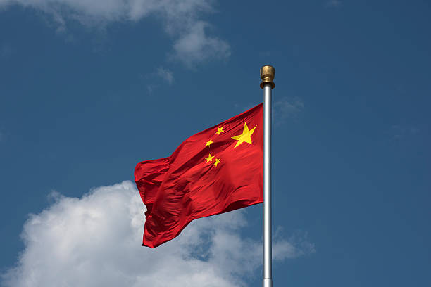 istock Flying Chinese National Falg against blue sky 628648472
