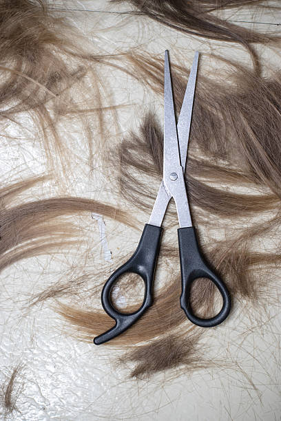 istock scissors and hair on floor 628648830