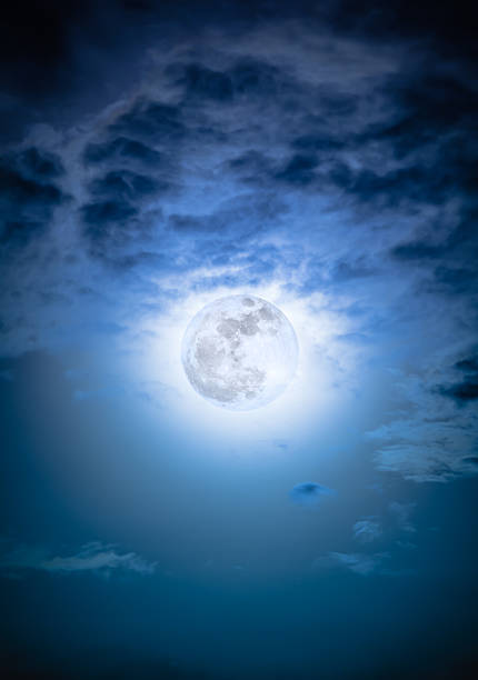 istock Nighttime sky with clouds and bright full moon with shiny. 628649456