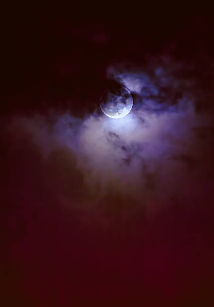 istock Nighttime sky with clouds and bright full moon with shiny. 628649464