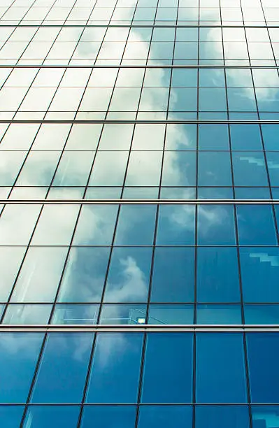 Blue sky and clouds reflection on the building window
