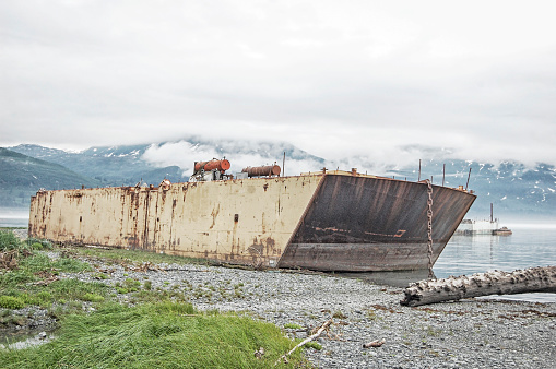 This abandoned vessel is located in the bay near Valdez, Alaska.  Abandoned and left to rust on the shoreline, this vessel shows its age and years of hard labor.