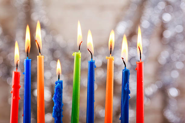 Hanukkah holiday menorah on wooden table over window background