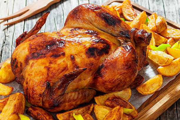 istock chicken barbecue in oven with potato wedges and leek 628659024