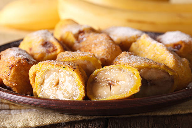 istock Pisang goreng fried bananas in batter on plate macro. Horizontal 628659258