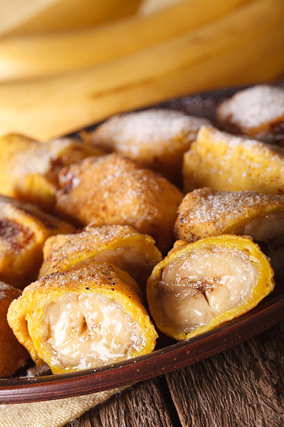 istock Fried bananas in batter on a plate closeup. vertical 628659334