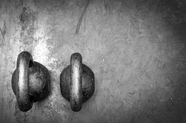 Kettle bells on the gym floor. Workout equipment. Black and white.