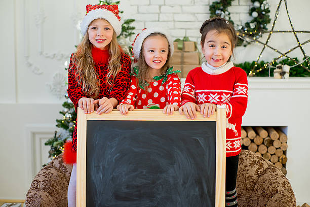 istock kids with black board at christmas time 628660866