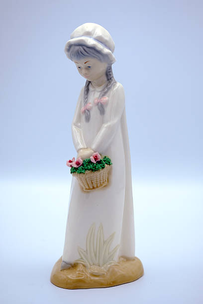 istock ceramic figurine of a girl with a baske 628661172