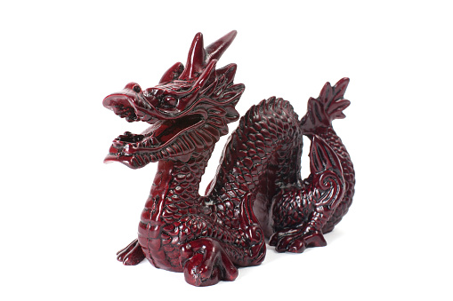 Brown traditional chinese dragon on white background. Feng Shui statuette.