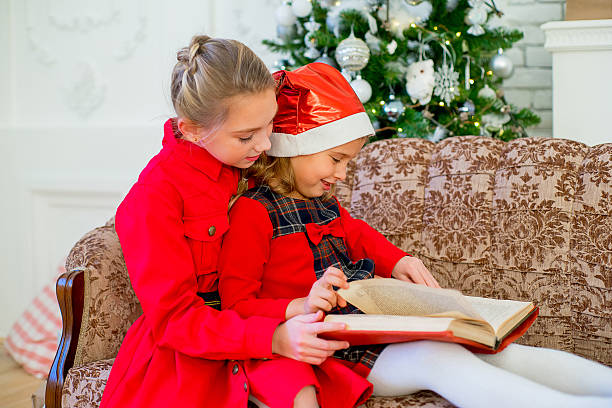 istock Kids reading a story book on Christmas time 628662420