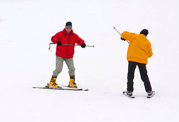 aerial view of shadows of skiers on snow on a ski slope in various positions as in a shadow theater