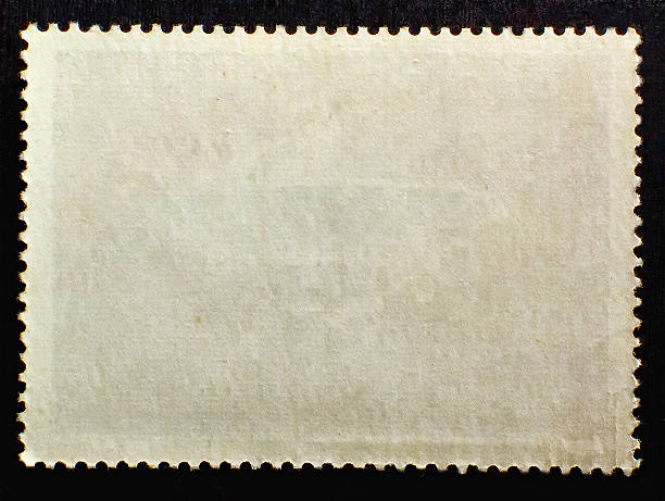 old posted stamp reverse  side isolated on black background - postage mark imagens e fotografias de stock