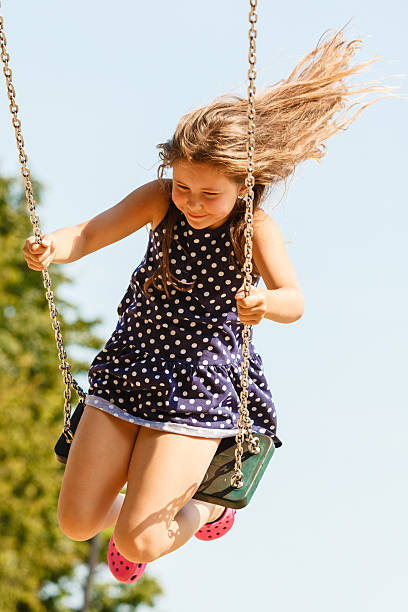 istock Girl swinging on swing-set. 628665012