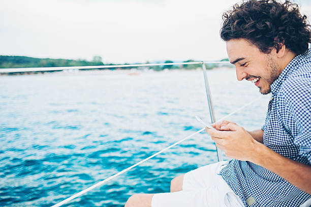istock Enjoying the sea travel and texting 628665752