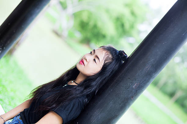 istock Thai girl leaning at black column 628666208