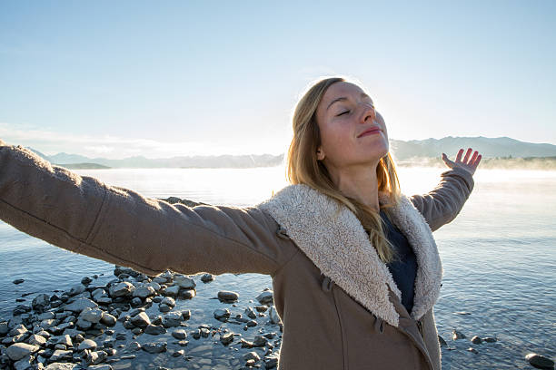 istock Young woman relaxing by the lake 628697108