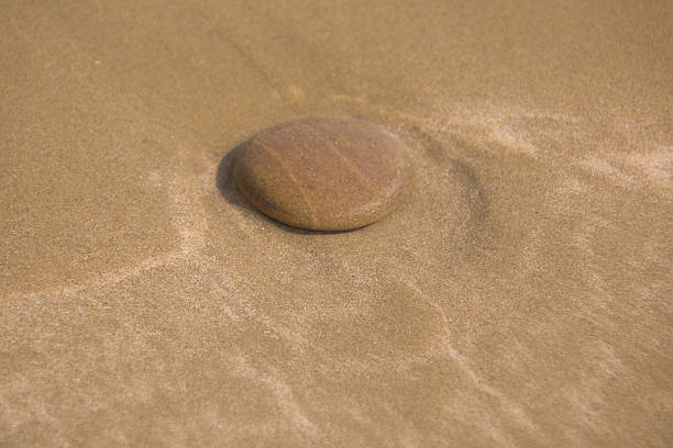 wet pebble in the sea water, on the sand