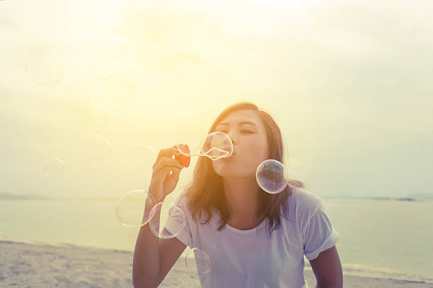 istock Asian young woman blowing bubbles 628728490