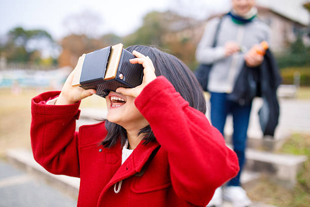 istock Young girl playing with virtual reality simulator with father 628735480