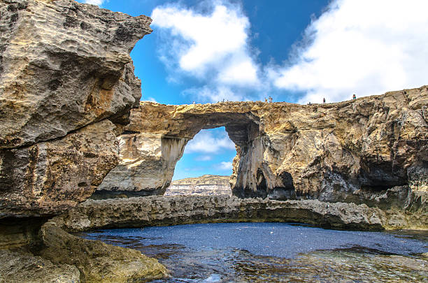 istock Tourists on the Azure Window in Gozo, Malta 628737234
