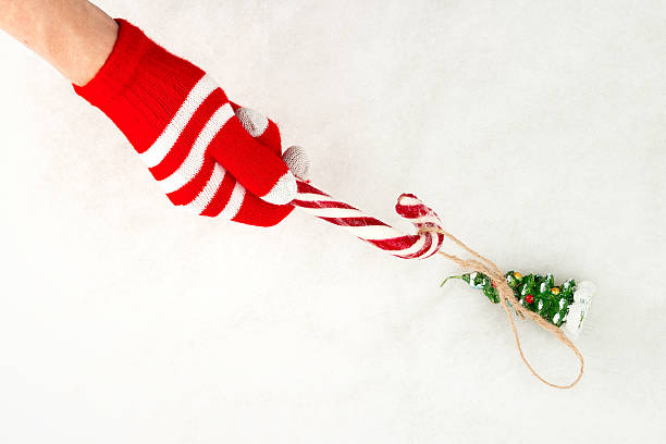 istock Christmas card, gloves on hands holding hook candy and grab 628746368
