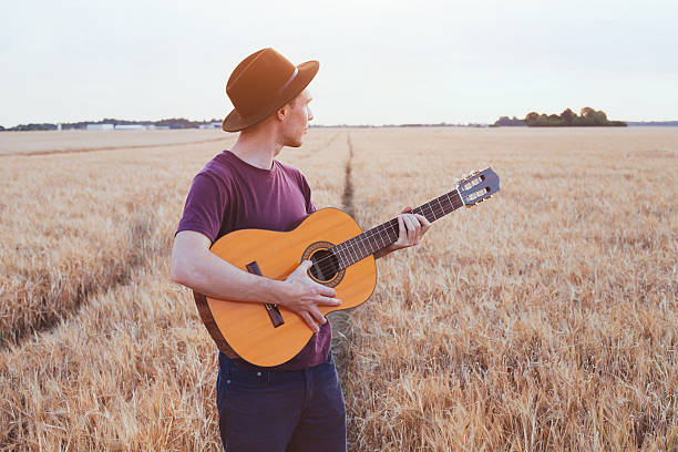 istock young man with guitar, music festival 628746750