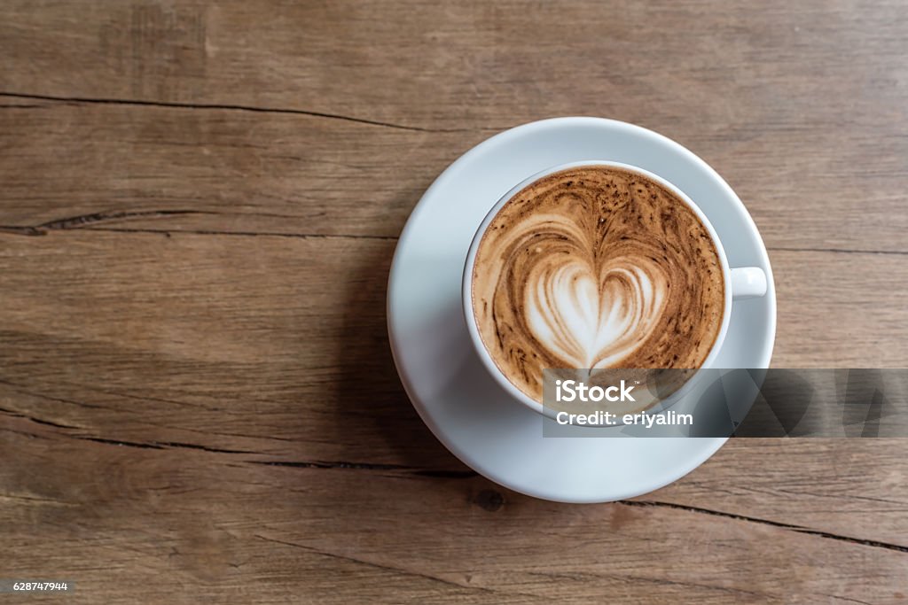 hot latte hot latte served in orange cup with latte art in fern shape Animal Markings Stock Photo