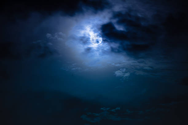 istock Nighttime sky with clouds and bright full moon with shiny. 628748658