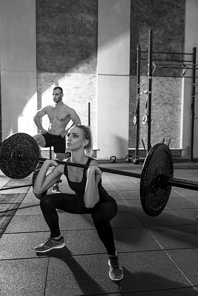istock Concentrated athletic woman exercising with a barbell 628748670