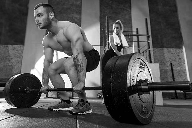istock Powerful athletic bodybuilder holding on to the barbell 628748798