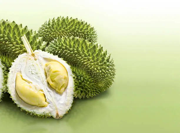 Photo of Durian on green solid background