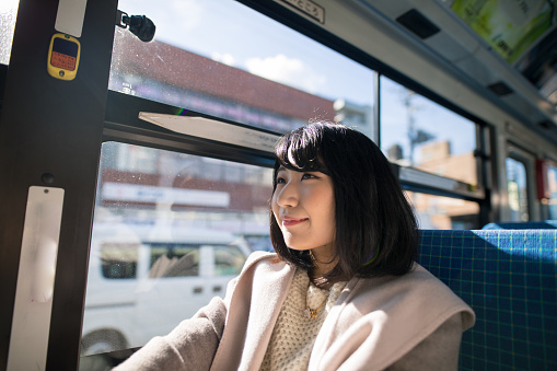 Young woman sitting in bus