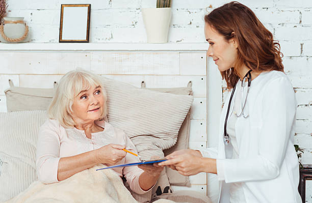 istock Professional female doctor examining elderly woman 628751804