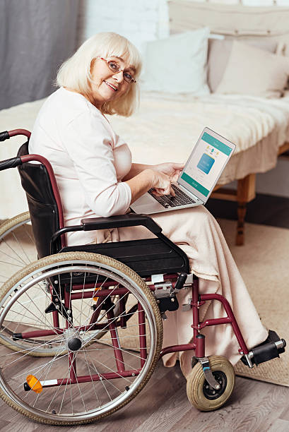 istock Joyful disabled woman using the Internet at home 628759776