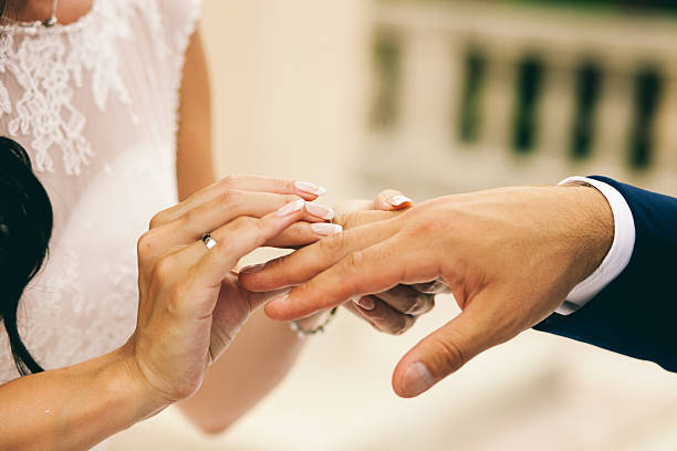 istock bride and groom holding hands together 628760246