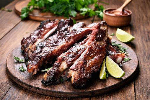 Grilled barbecue pork ribs on wooden board
