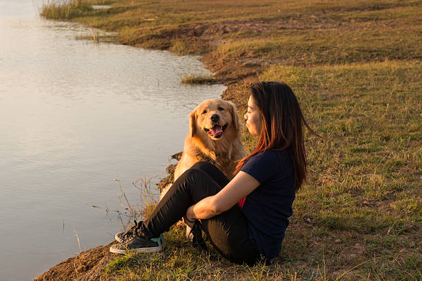 istock woman and golden dog on riverside 628761528