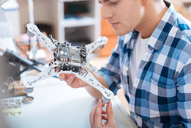Close up of young man holding drone detail