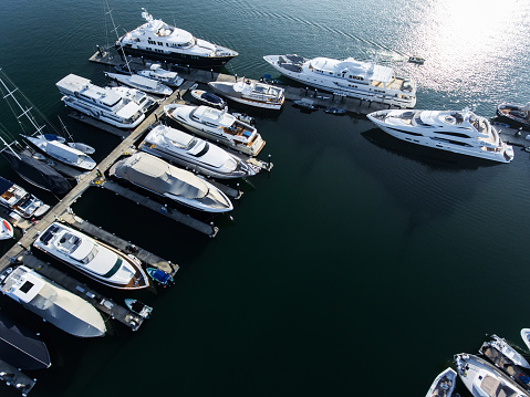 Aerial photo from a drone of a row of luxury super yachts moored in Port Vauban, Antibes, Cote D'Azur, France