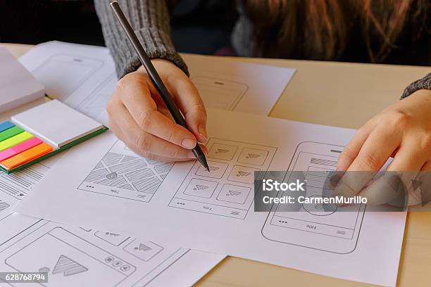 Designer Wireframing A Mobile App Stock Photo - Download Image Now - Graphic Designer, Plan - Document, Drawing - Activity