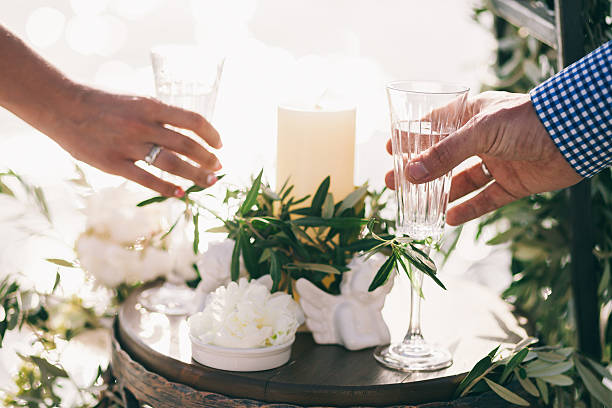 istock bride and groom holding hands together 628789846