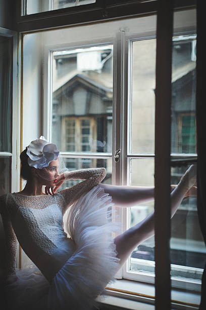 istock Beautiful balerina looking trough window 628790434
