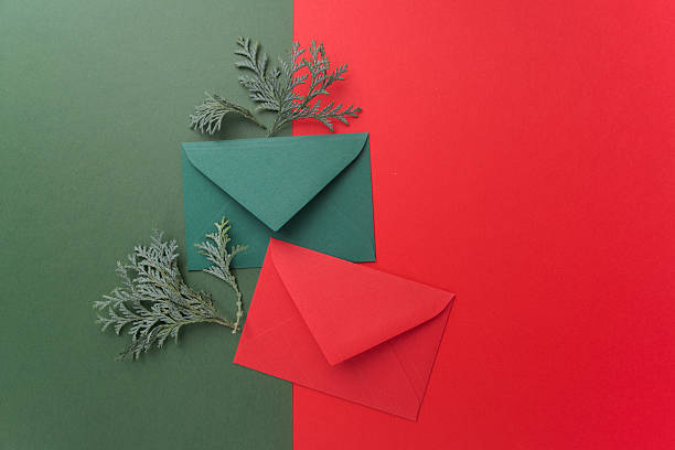 istock Red and green envelopes on christmas holiday background. Flat lay. 628792102